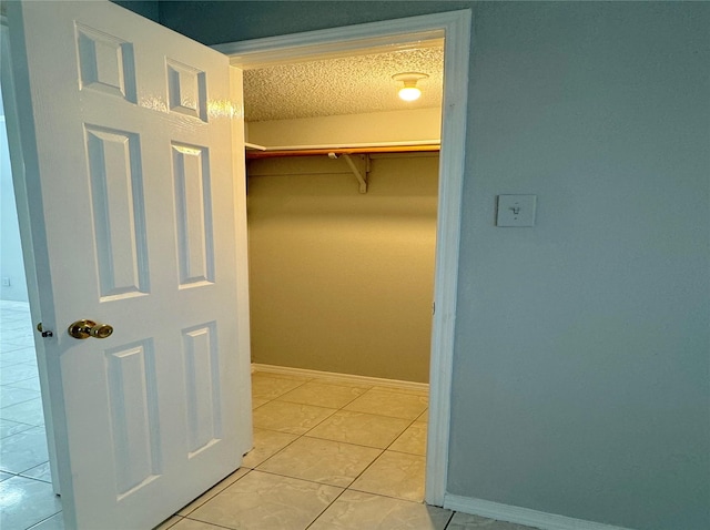 walk in closet featuring light tile patterned flooring
