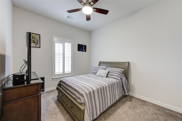 bedroom featuring baseboards, a ceiling fan, visible vents, and light colored carpet