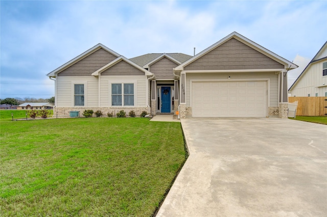 craftsman house featuring an attached garage, brick siding, fence, driveway, and a front lawn