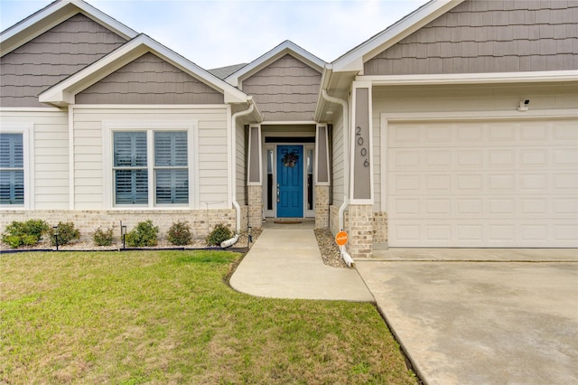 view of front of house featuring concrete driveway, a front lawn, an attached garage, and brick siding