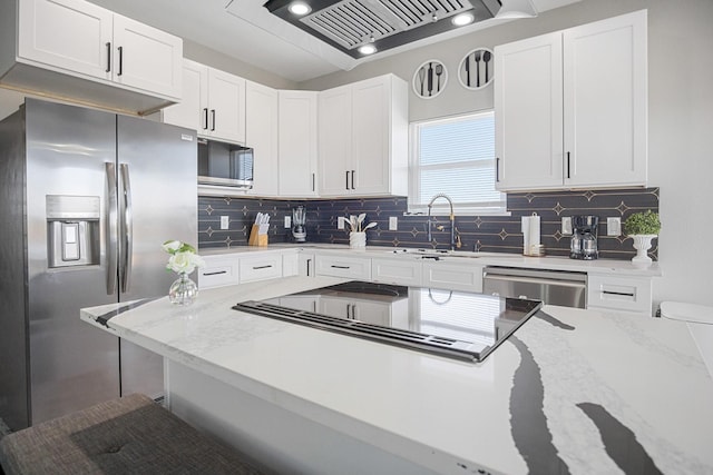 12971/2 Mabry St, Gilchrist, TX 77617 - kitchen with appliances with stainless steel finishes, light stone counters, and white cabinets