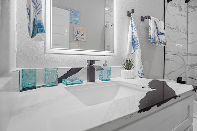 12971/2 Mabry St, Gilchrist, TX 77617 - bathroom with a shower, a textured wall, and vanity