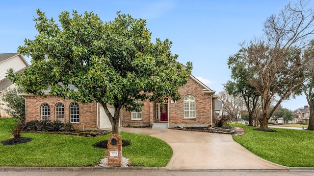 obstructed view of property with brick siding, concrete driveway, and a front yard