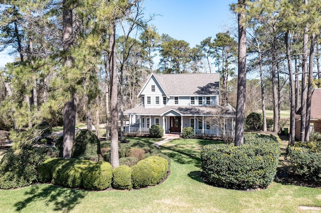 view of front of property with a porch and a front yard