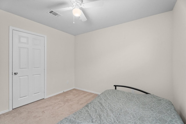 bedroom with light carpet, baseboards, visible vents, and ceiling fan