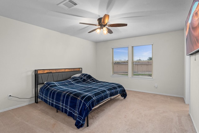 carpeted bedroom with ceiling fan, visible vents, and baseboards