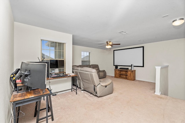 cinema featuring a ceiling fan, carpet, and visible vents