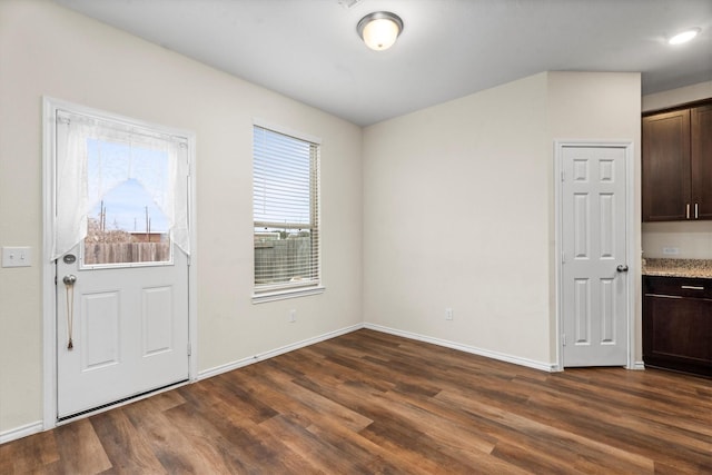 interior space featuring dark wood finished floors and baseboards