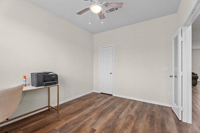 interior space featuring ceiling fan, baseboards, visible vents, and dark wood finished floors
