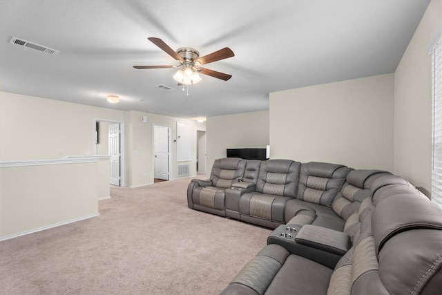 living area with light carpet, visible vents, and a ceiling fan