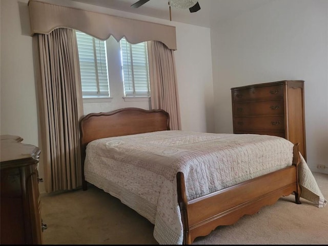 bedroom with light carpet and a ceiling fan