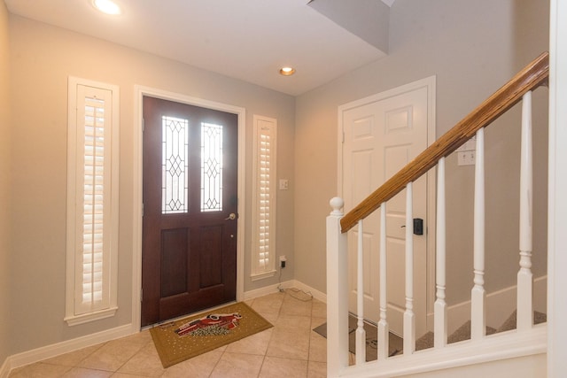 foyer featuring stairs, light tile patterned floors, recessed lighting, and baseboards