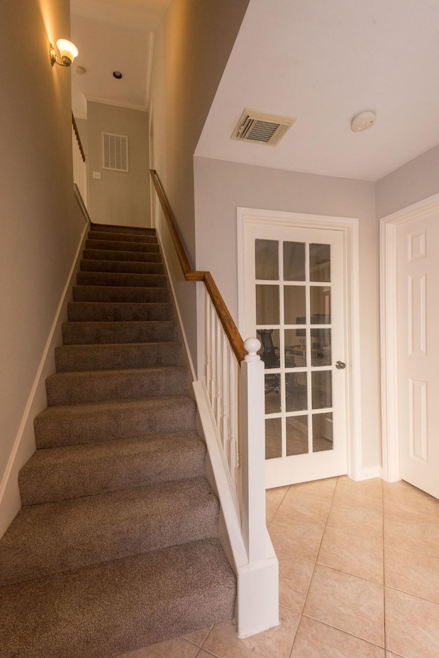 stairs with visible vents and tile patterned floors