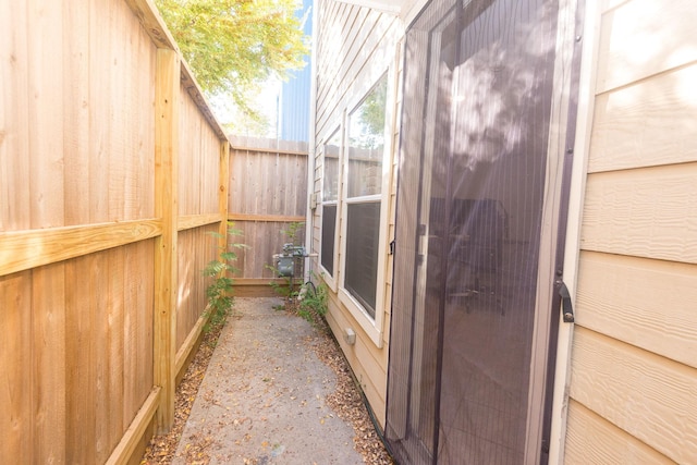 view of side of home featuring fence