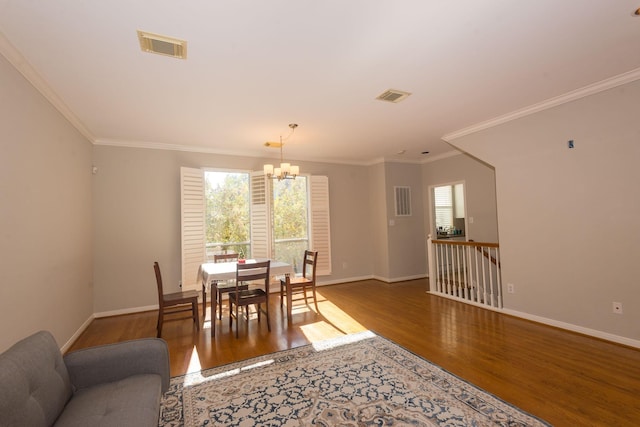 dining space featuring visible vents, baseboards, and wood finished floors