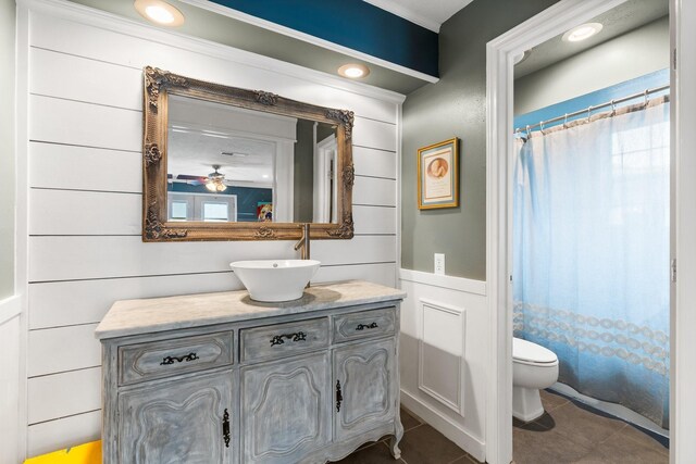 full bath with a shower with shower curtain, vanity, toilet, and tile patterned floors