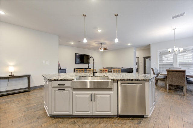 kitchen with a sink, a center island with sink, white cabinetry, and stainless steel dishwasher