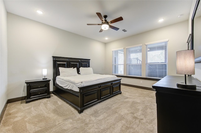 bedroom with baseboards, recessed lighting, visible vents, and light colored carpet