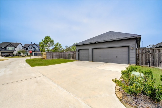 exterior space with driveway, a residential view, and fence