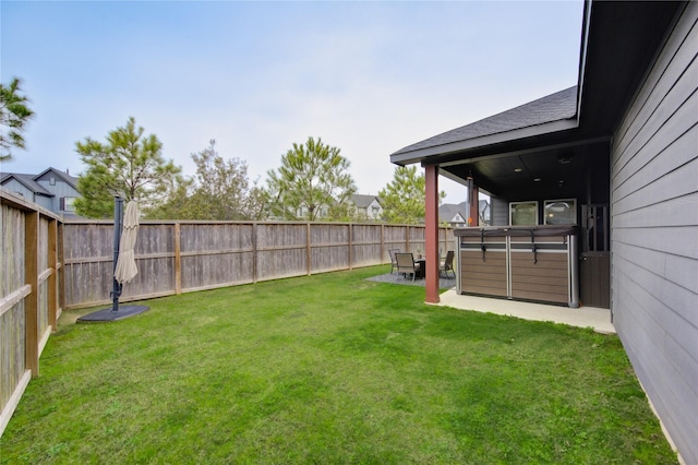 view of yard featuring a fenced backyard, a patio, and a hot tub