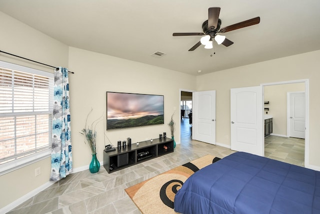 bedroom featuring ceiling fan, visible vents, and baseboards