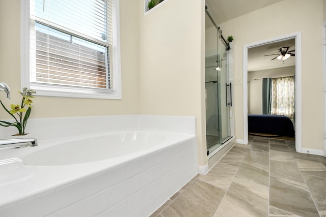 ensuite bathroom with a wealth of natural light, a garden tub, a shower stall, and ensuite bath