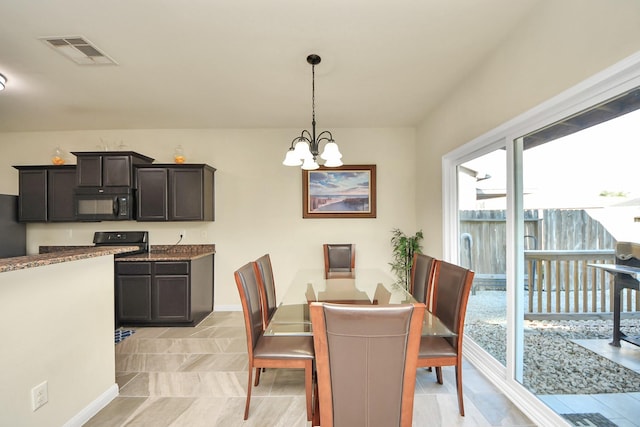 dining space with a chandelier, visible vents, and baseboards