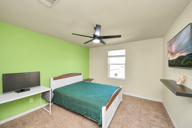 bedroom with a ceiling fan, light colored carpet, visible vents, and baseboards