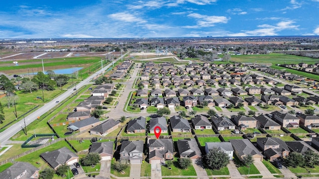 bird's eye view with a water view and a residential view