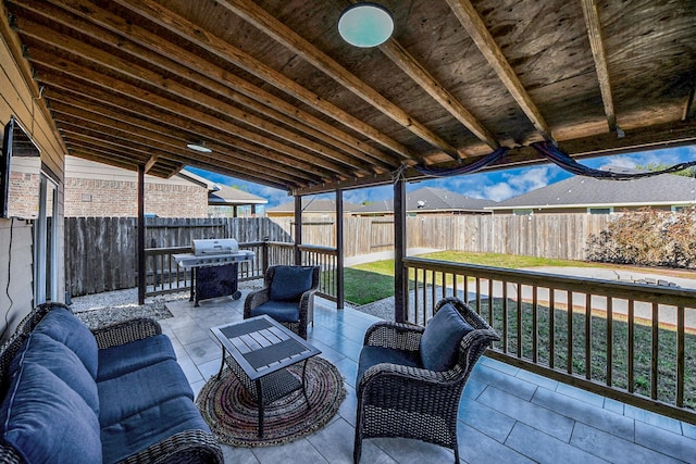 wooden deck featuring a patio area, a fenced backyard, an outdoor living space, and grilling area