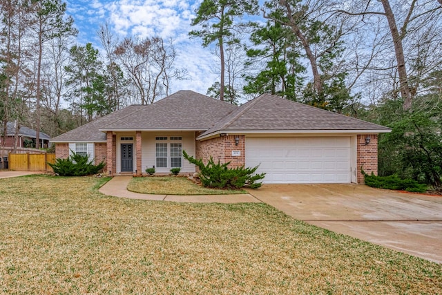 ranch-style house featuring a garage, brick siding, a shingled roof, driveway, and a front yard