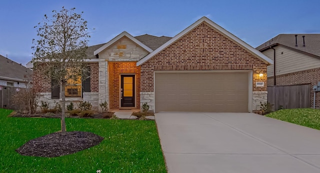 view of front of property featuring a garage, stone siding, and brick siding