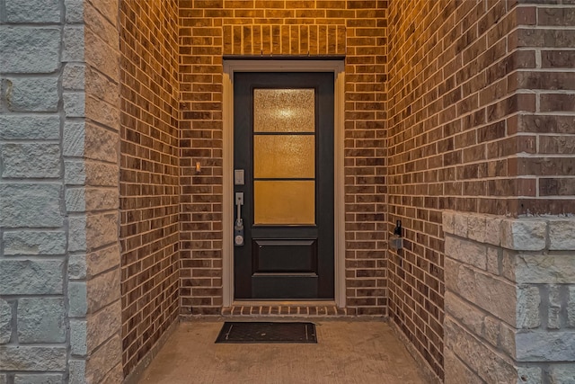 property entrance with brick siding