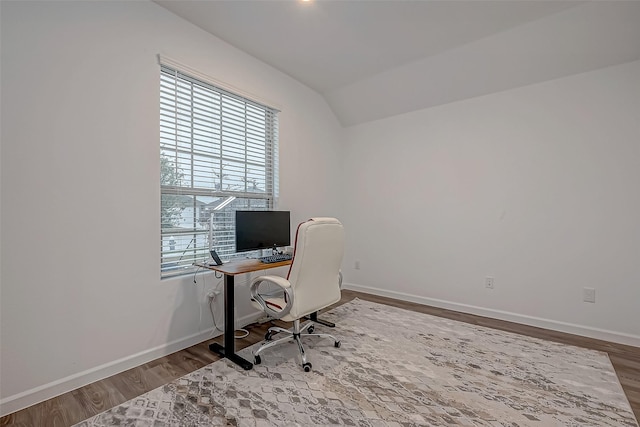 home office with baseboards, vaulted ceiling, and wood finished floors