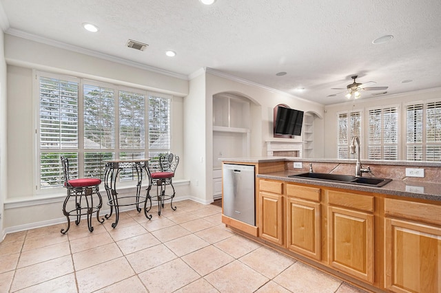 kitchen featuring crown molding, visible vents, a sink, and stainless steel dishwasher