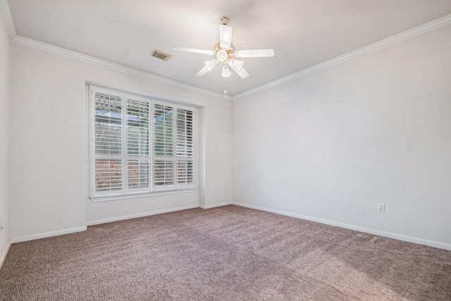 empty room with ornamental molding, visible vents, baseboards, and a ceiling fan