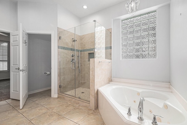 full bathroom with plenty of natural light, a shower stall, a tub with jets, and tile patterned flooring