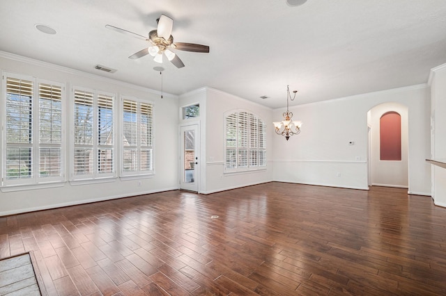 empty room with ceiling fan with notable chandelier, arched walkways, wood finished floors, and a wealth of natural light