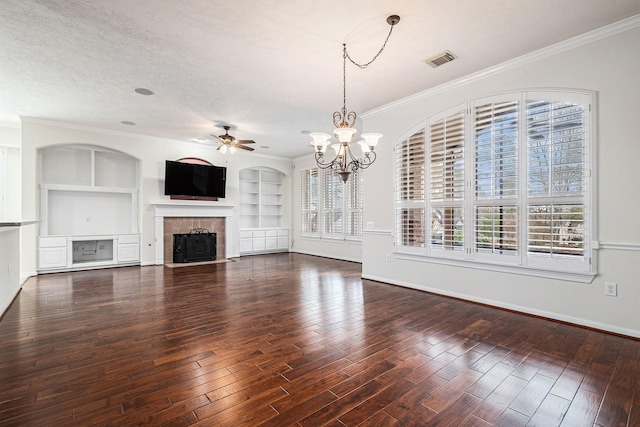 unfurnished living room with built in features, a fireplace, visible vents, a textured ceiling, and wood finished floors