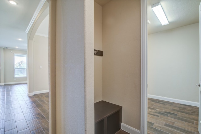 hallway with arched walkways, recessed lighting, baseboards, and wood tiled floor