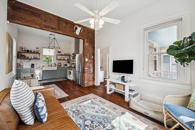 living room with ceiling fan and dark wood-type flooring