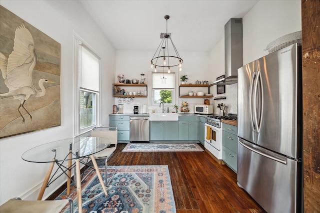 kitchen featuring stainless steel appliances, open shelves, a sink, dark wood-style floors, and wall chimney exhaust hood