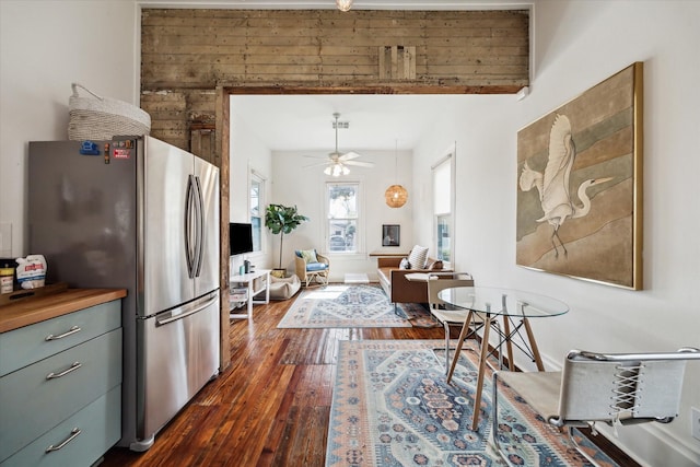 kitchen featuring ceiling fan, dark wood-style flooring, and freestanding refrigerator