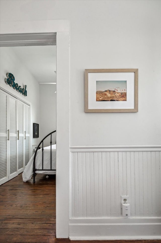 room details featuring a wainscoted wall and wood finished floors