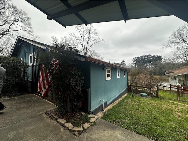 view of home's exterior featuring a yard and fence