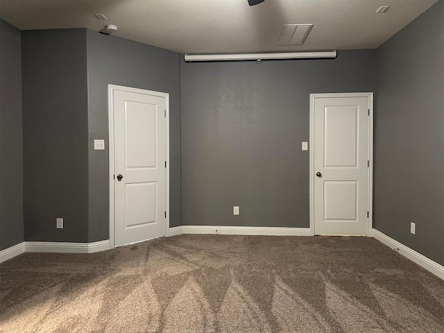 empty room with baseboards and carpet floors