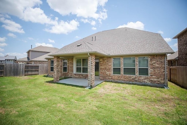 back of property with a patio area, brick siding, a fenced backyard, and a lawn