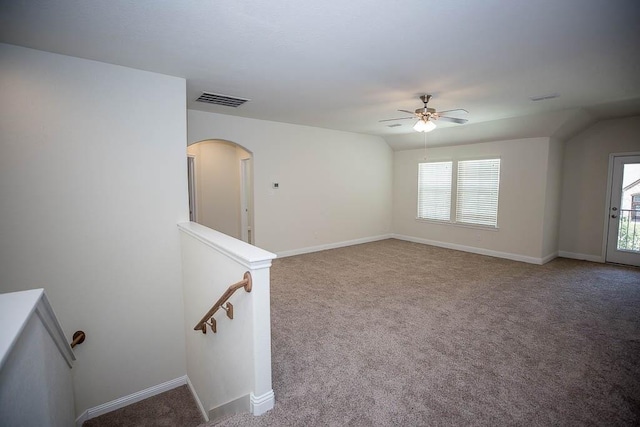 empty room featuring visible vents, plenty of natural light, carpet floors, and a ceiling fan