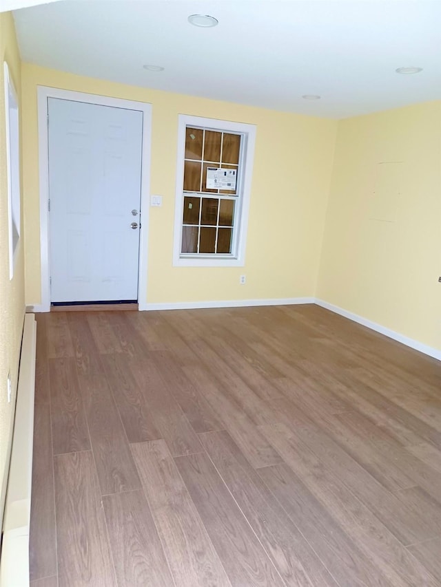 spare room with light wood-style flooring and baseboards