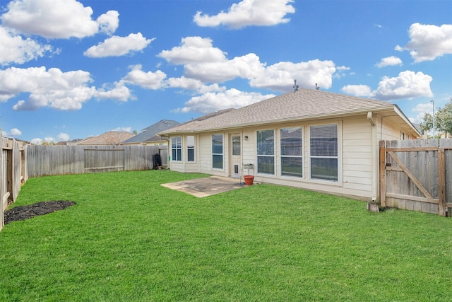 rear view of property featuring a gate, a fenced backyard, a yard, and roof with shingles